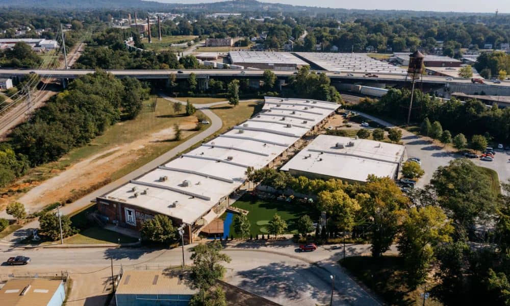 Aerial view of a commercial property with multiple buildings, parking areas, roads, and surrounding development for an ALTA survey, including Table A requirements